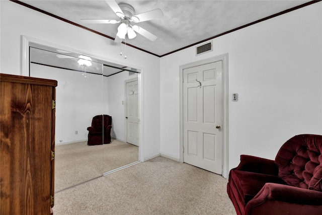 sitting room featuring carpet flooring, a ceiling fan, ornamental molding, and baseboards
