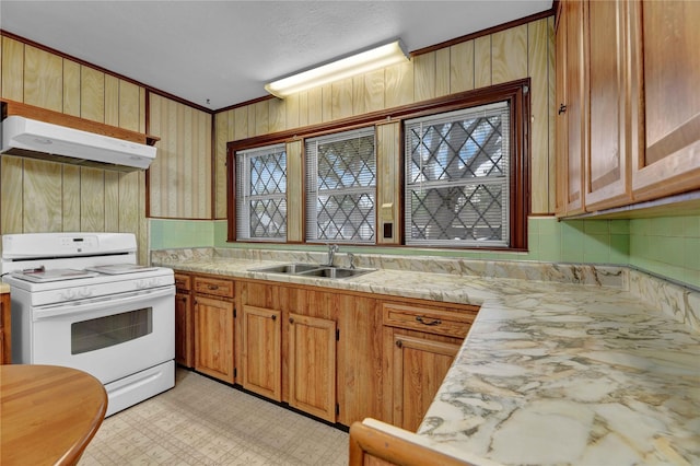 kitchen with light countertops, a sink, under cabinet range hood, and white range with electric cooktop