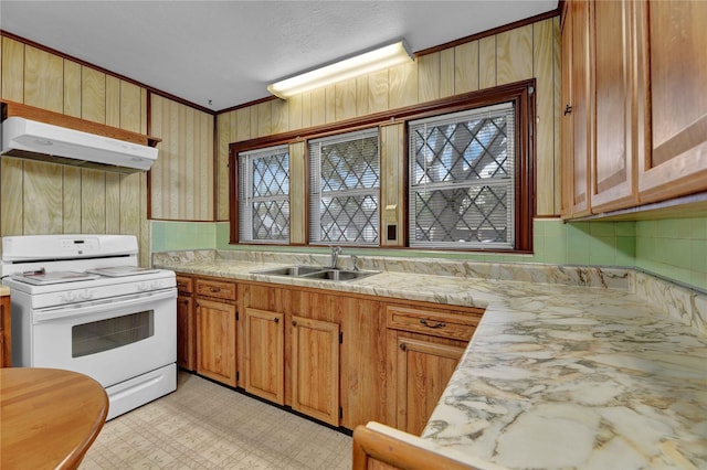 kitchen featuring under cabinet range hood, a sink, white gas range oven, backsplash, and light countertops