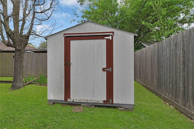 view of shed with a fenced backyard