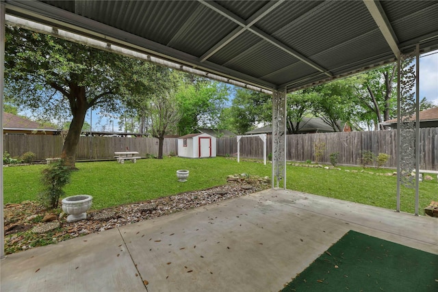 view of patio / terrace featuring a storage shed, a fenced backyard, and an outdoor structure