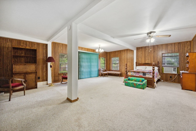 bedroom with wood walls, carpet, multiple windows, and a chandelier