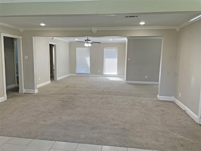 carpeted empty room featuring crown molding and ceiling fan