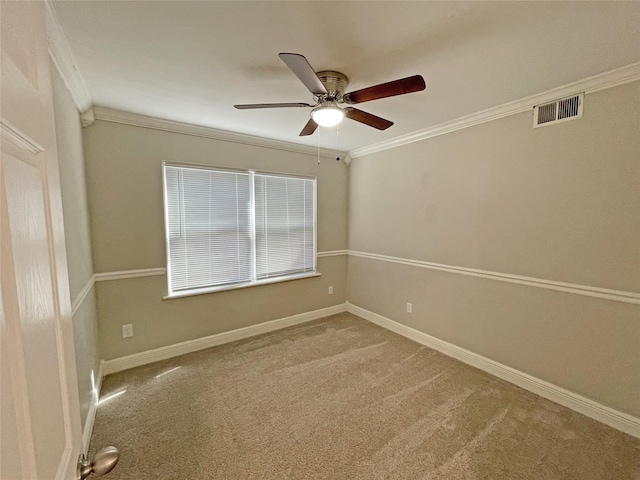 unfurnished room featuring crown molding, ceiling fan, and carpet