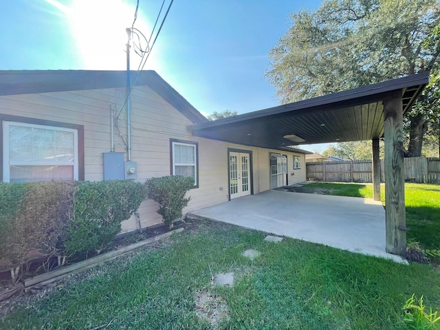 exterior space featuring a patio area, french doors, and a lawn