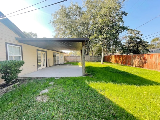 view of yard featuring a patio and french doors