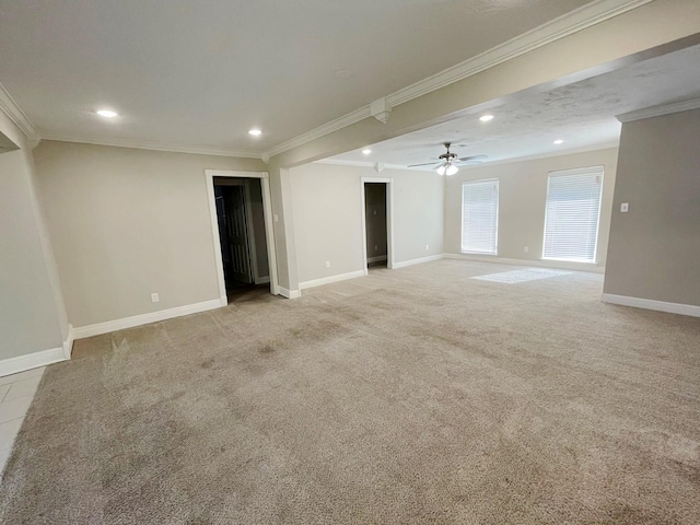 basement with ornamental molding, light carpet, and ceiling fan