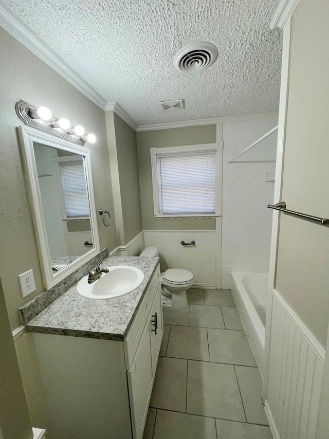 bathroom with vanity, toilet, crown molding, tile patterned floors, and a textured ceiling