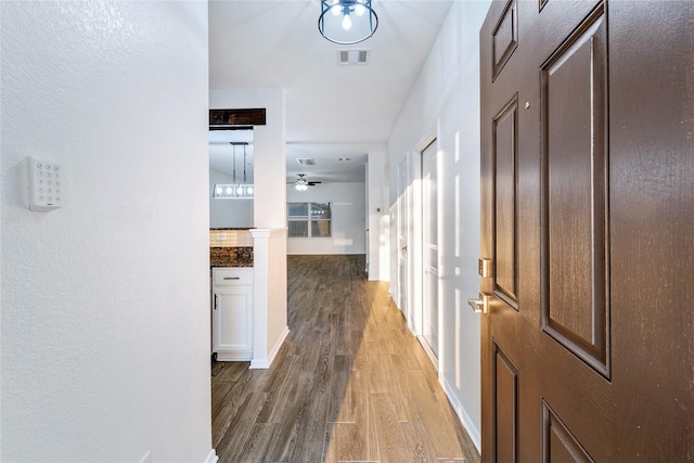 corridor featuring hardwood / wood-style floors