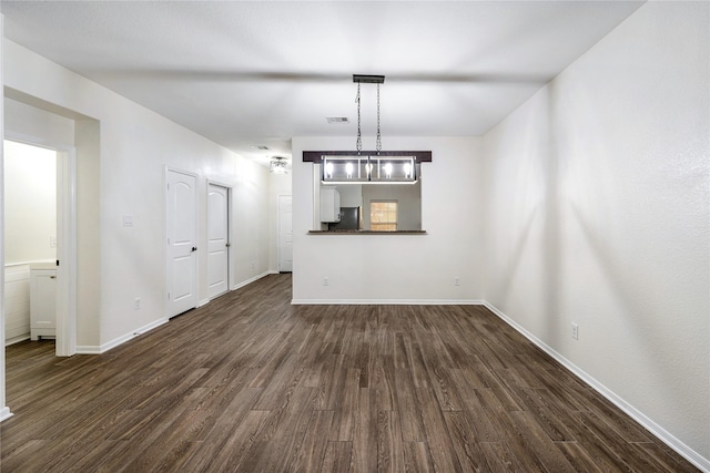 unfurnished living room with dark hardwood / wood-style floors