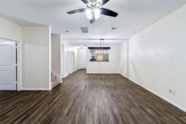 unfurnished living room featuring ceiling fan and dark hardwood / wood-style flooring