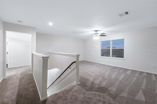 carpeted empty room featuring ceiling fan