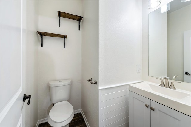 bathroom featuring vanity, toilet, and hardwood / wood-style floors