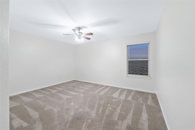 spare room with light colored carpet and ceiling fan