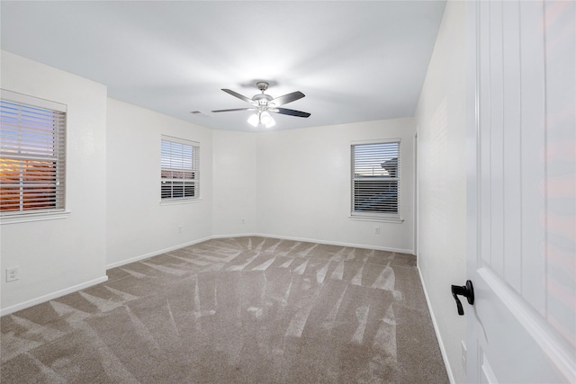 spare room featuring ceiling fan and carpet flooring