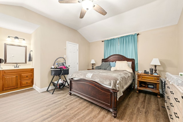 bedroom with lofted ceiling, sink, wood-type flooring, and ceiling fan