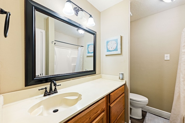 bathroom with vanity, toilet, a textured ceiling, and a shower with shower curtain