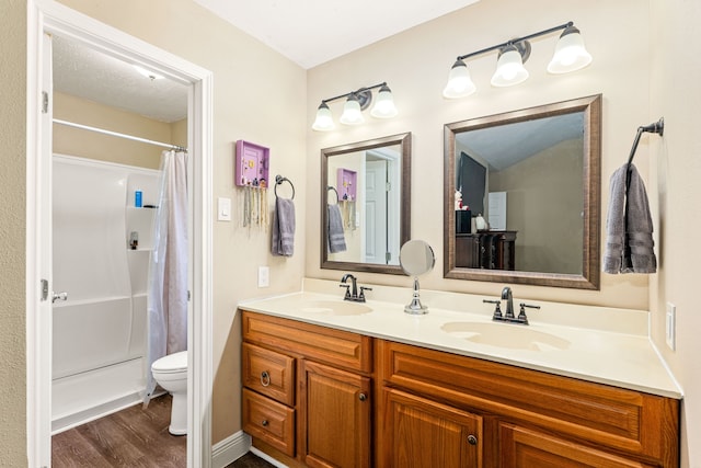 bathroom with vanity, toilet, and hardwood / wood-style floors