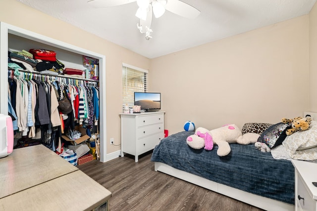 bedroom featuring a closet, dark hardwood / wood-style floors, and ceiling fan