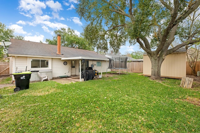 view of yard with a trampoline and a patio