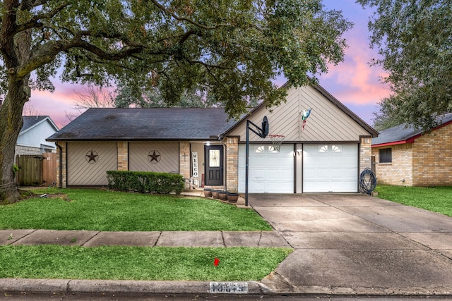 view of front of home with a garage and a lawn