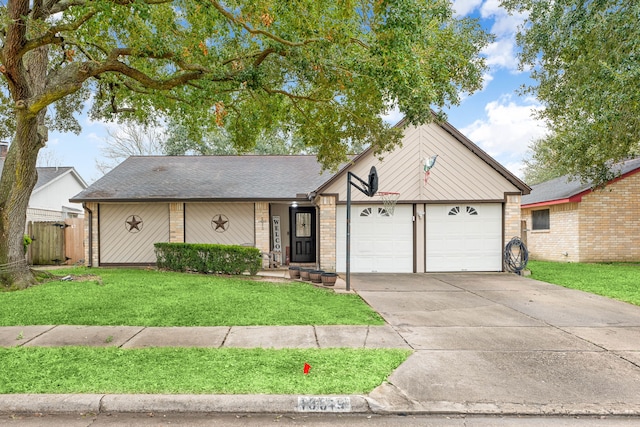 view of front of property with a garage and a front lawn