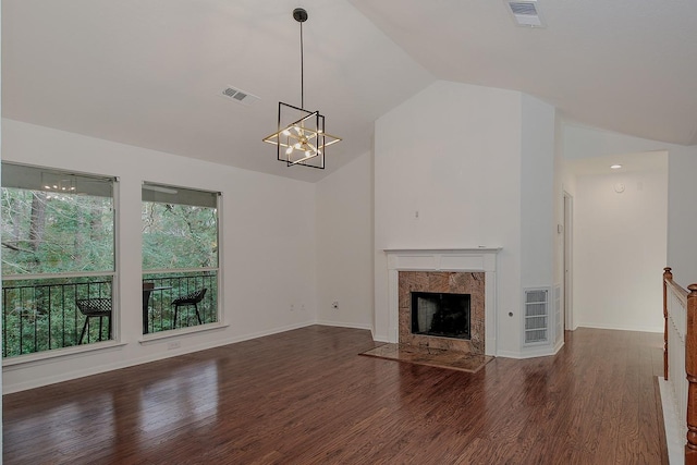 unfurnished living room with a premium fireplace, high vaulted ceiling, an inviting chandelier, and dark hardwood / wood-style flooring