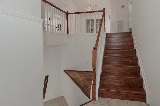 stairway with tile patterned floors