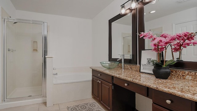 bathroom featuring tile patterned flooring, vanity, and shower with separate bathtub