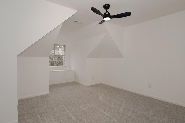 bonus room with vaulted ceiling, light colored carpet, and ceiling fan