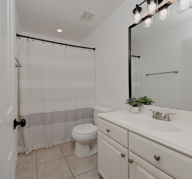 bathroom featuring tile patterned flooring, vanity, and toilet