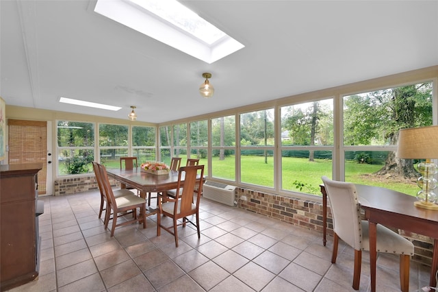 sunroom featuring a wall mounted air conditioner and a skylight