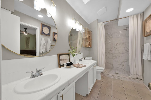 bathroom with tile patterned floors, toilet, tasteful backsplash, vanity, and curtained shower