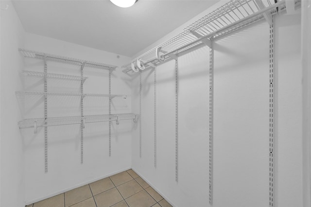 spacious closet featuring light tile patterned floors