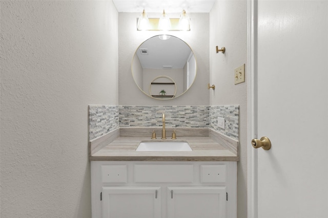 bathroom with vanity and decorative backsplash