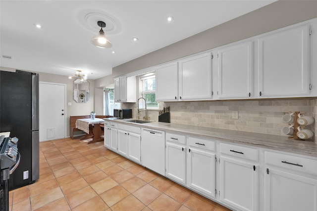 kitchen with white cabinetry, stainless steel appliances, sink, and decorative backsplash