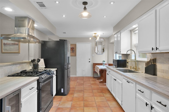 kitchen featuring sink, white dishwasher, island range hood, white cabinets, and gas range