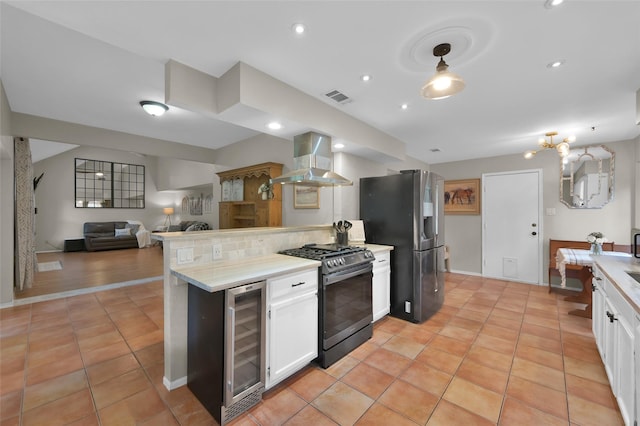 kitchen featuring wine cooler, white cabinetry, stainless steel appliances, and wall chimney exhaust hood