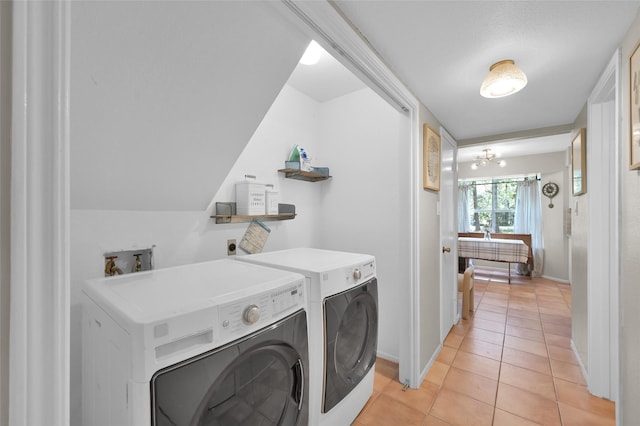 washroom with separate washer and dryer and light tile patterned floors