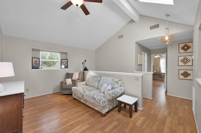 living room with ceiling fan, lofted ceiling with skylight, and light hardwood / wood-style flooring