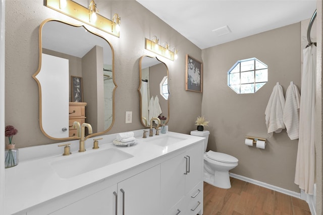 bathroom with vanity, hardwood / wood-style flooring, and toilet