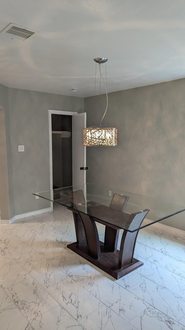 unfurnished dining area featuring marble finish floor, visible vents, and baseboards