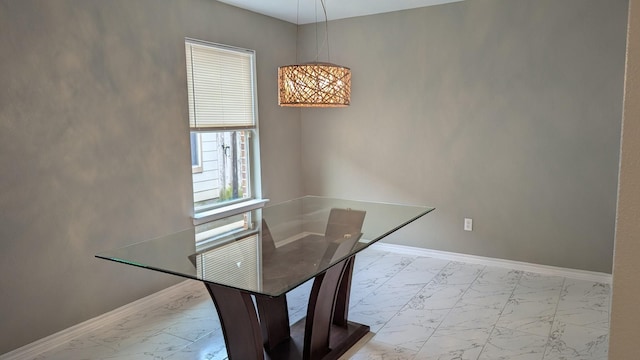 dining area featuring marble finish floor and baseboards