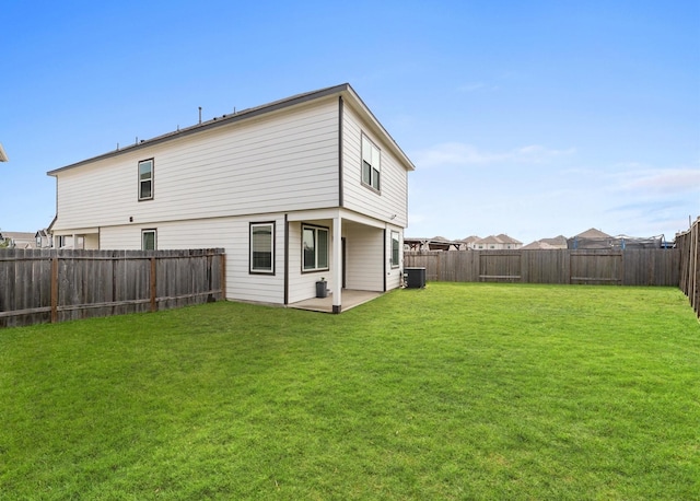 back of property featuring a yard, a patio, and a fenced backyard