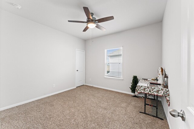 interior space with ceiling fan and baseboards