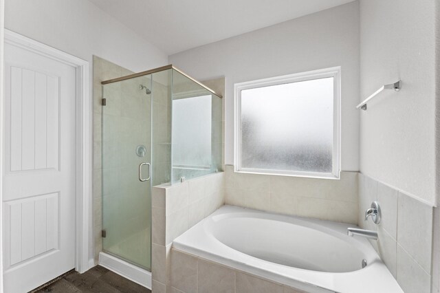 full bath with a garden tub and a shower stall