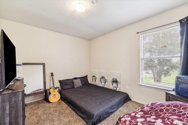 bedroom with carpet floors and a textured ceiling