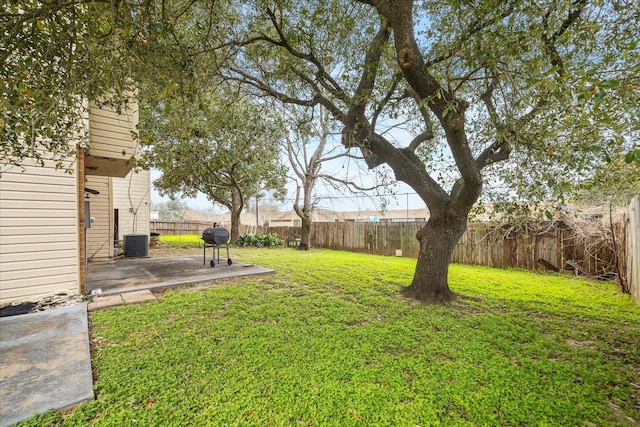 view of yard featuring a patio, central AC, and a fenced backyard