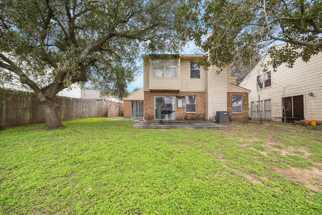 back of house with brick siding, a yard, a patio, cooling unit, and a fenced backyard