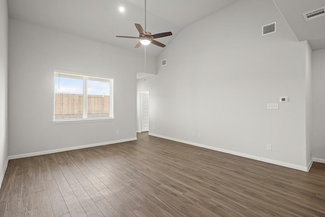 spare room featuring a ceiling fan, visible vents, dark wood finished floors, and baseboards